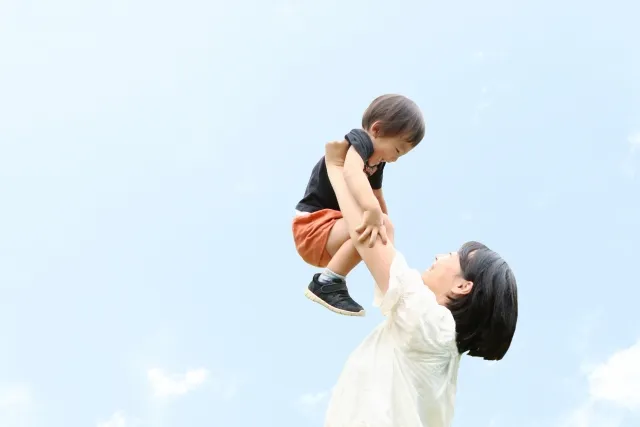 子どもを抱きかかえる画像